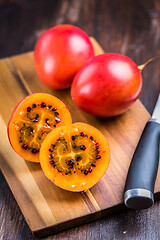 Image showing Organic tamarillo (tree tomato) on cutting board