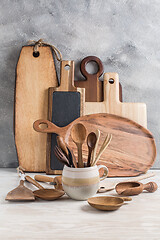 Image showing Assortment of wooden cutting boards and kitchen utensils