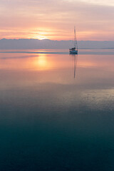 Image showing Moored sailboat in the bay and sunrise