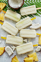 Image showing Homemade vegan popsicles made with coconut milk and pineapple. Delicious healthy summer snack