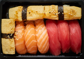 Image showing Nigiri sushi set in plastic container ready for takeout delivery. Closeup of take away lunch box