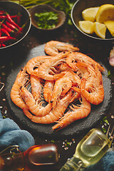 Image showing Fresh and raw big shrimps ready to be prepared. With various ingredients on side