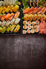 Image showing Sushi take-away plastic tray with diffent kinds of rolls and copy space. Take-away food concept.