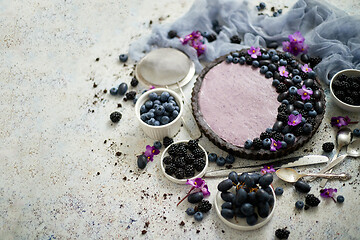 Image showing Homemade blackberry tart. Sweet pie with blackberrym blueberry and grapes on stone table