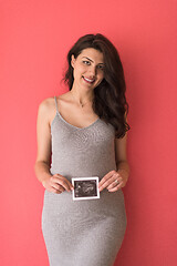 Image showing happy pregnant woman showing ultrasound picture