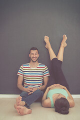 Image showing pregnant couple relaxing on the floor