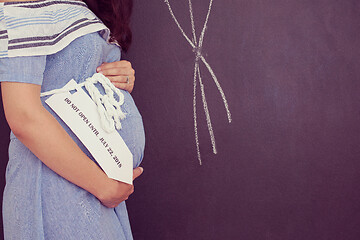 Image showing Portrait of pregnant woman in front of black chalkboard