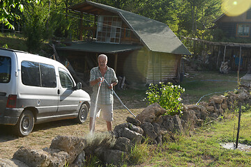 Image showing gardener watering the plants