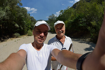 Image showing dad and son taking selfie photos