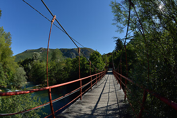 Image showing wooden bridge over wild river