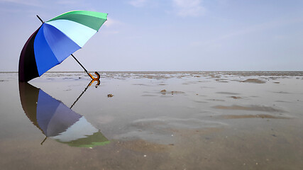 Image showing Colorful umbrella and reflection