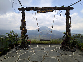 Image showing Wooden swing on the rope with view of Batur volcano