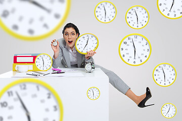 Image showing Young woman can\'t wait to go home from the nasty office