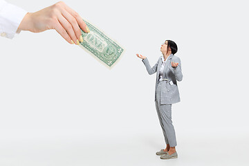 Image showing Young woman getting a small salary