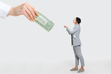 Image showing Young woman getting a small salary