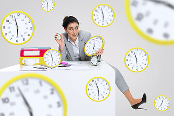 Image showing Young woman can\'t wait to go home from the nasty office