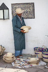 Image showing Elder street vendor selling handmade souvenirs 