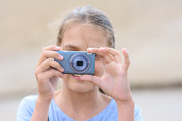 Image showing Girl takes pictures with a digital camera