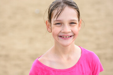 Image showing Portrait of a happy ten year old girl with wet hair swimming in the sea