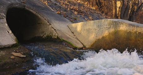 Image showing Large sewage tunnel with filth flowing out