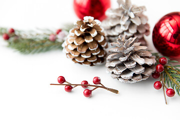 Image showing christmas balls and fir branches with pine cones