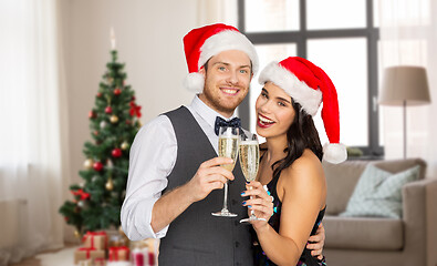 Image showing couple with champagne glasses at home on christmas