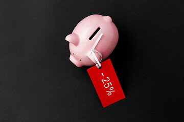 Image showing piggy bank with red sale tag on black