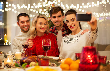 Image showing friends taking selfie at christmas dinner