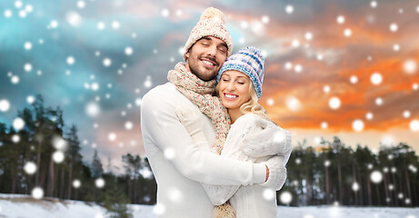 Image showing smiling couple in winter clothes hugging