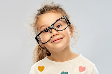 Image showing smiling little girl in crookedly placed glasses