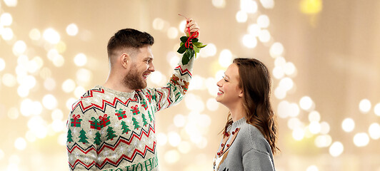 Image showing happy couple with mistletoe on christmas