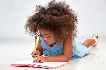 Image showing happy little african american girl with sketchbook