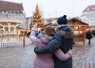 Image showing happy senior couple hugging at christmas market