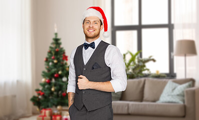 Image showing happy man in santa hat and suit at christmas