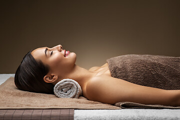 Image showing young woman lying at spa or massage parlor