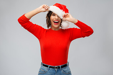 Image showing happy young woman in santa hat on christmas