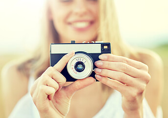 Image showing close up of woman photographing with film camera