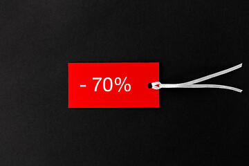 Image showing red tags with discount signs on black background