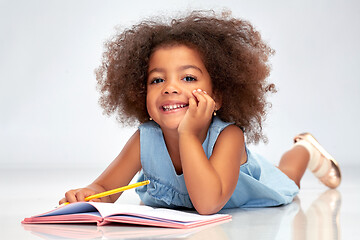 Image showing happy little african american girl with sketchbook