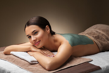 Image showing woman with blue clay mask in spa