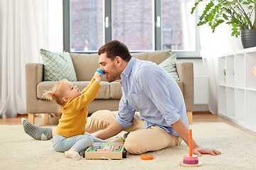 Image showing father playing with little baby daughter at home