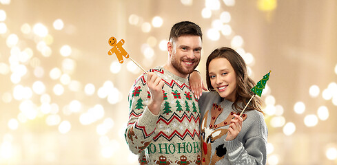 Image showing couple with christmas party props in ugly sweaters