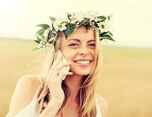 Image showing happy young woman calling on smartphone at country