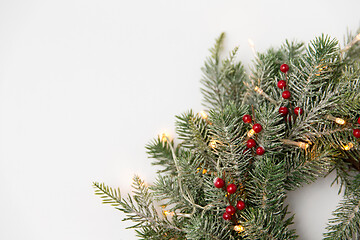 Image showing christmas fir wreath with berries and lights