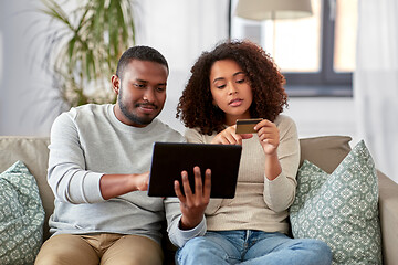 Image showing couple with tablet pc and credit card at home