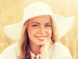 Image showing close up of happy woman in sun hat on cereal field