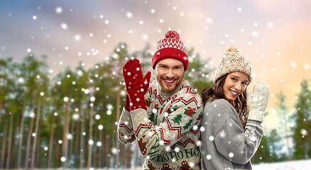 Image showing couple in christmas ugly sweaters in winter