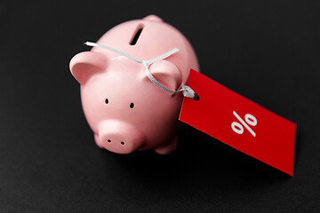 Image showing piggy bank with red sale tag on black