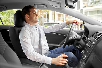 Image showing smiling man or driver driving car