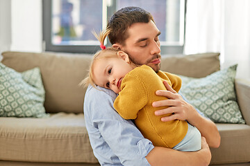 Image showing loving father holding baby daughter at home